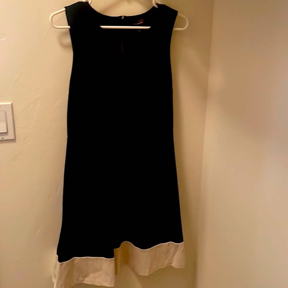 Knee length black dress with white trim